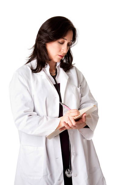 Female doctor physician in white coat and stethoscope writing medical prescription note in patient chart, isolated. - Fotó, kép