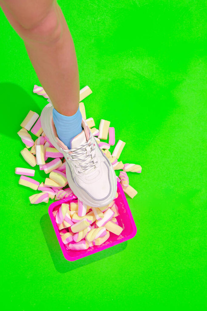 Summer sweet unrecognizable sneakers leg. Fashion candy minimal style. Kawaii party. Lolli pop scene - Fotoğraf, Görsel