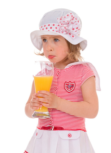 charming little girl with a glass of juice. - Φωτογραφία, εικόνα