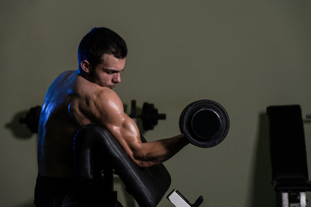 Young Man Doing Exercise For Biceps - Photo, image