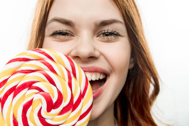 emotional woman with open mouth big multicolored lollipop of joy - Photo, Image