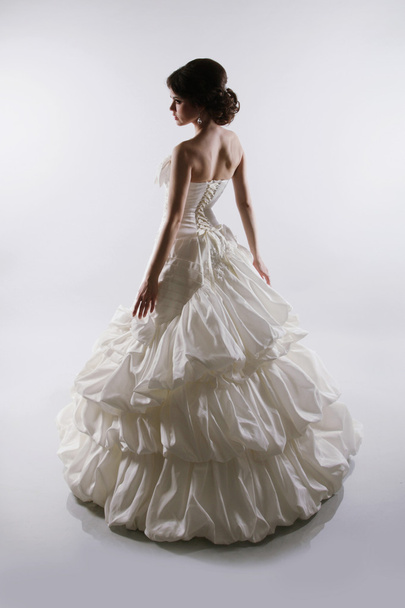 Glamorous bride woman in magnificent wedding dress isolated on g - Φωτογραφία, εικόνα