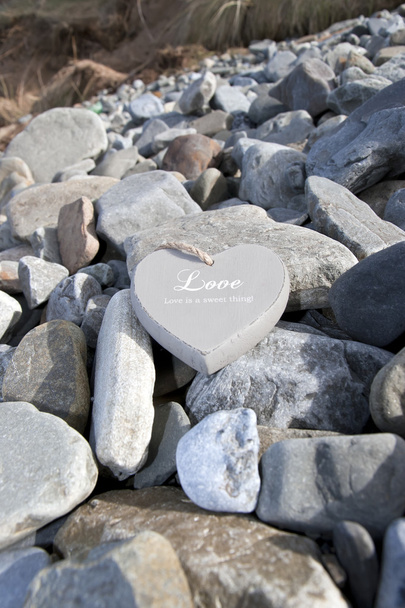 Loveing wooden heart on the rocks - Photo, Image