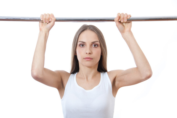 Woman exercising on pull-up bar - Foto, imagen
