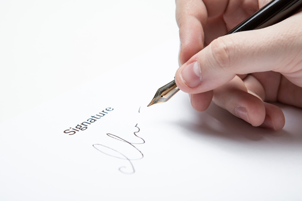 pen in the man's hand and signature - Photo, Image