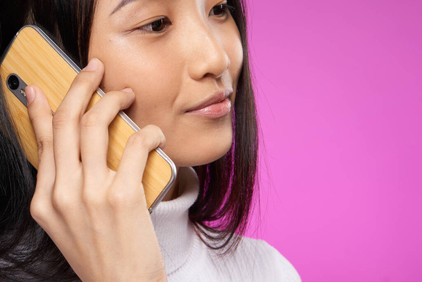 bastante asiático mujer hablando en el teléfono tecnología close-up - Foto, Imagen