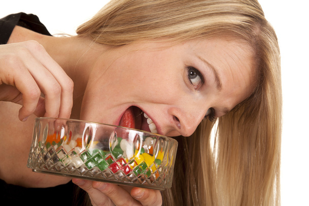 woman eating jelly beans tongue in bowl - Foto, immagini