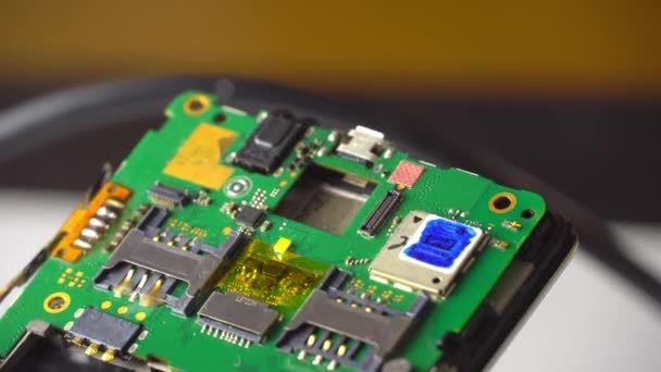 Fix the phone. technician or master examines smartphone motherboard macro - Footage, Video