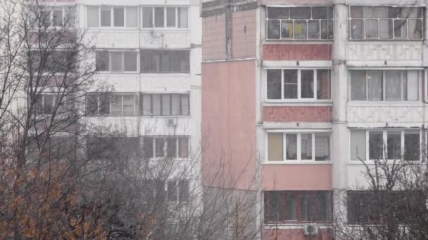 Balconies of multi-storey residential buildings built in the Soviet Union during snowfall and blizzards. - Materiaali, video