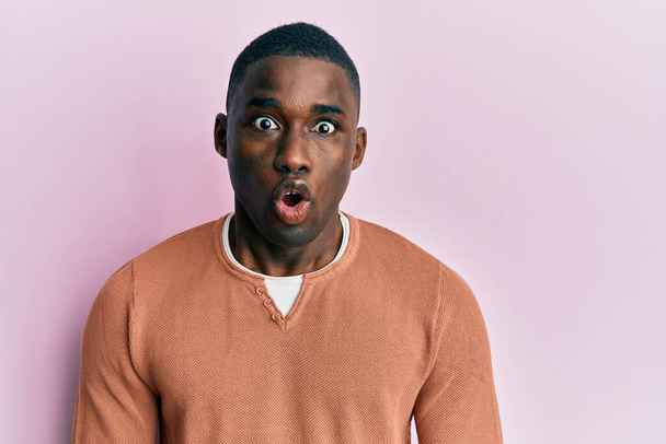 Young african american man wearing casual clothes afraid and shocked with surprise expression, fear and excited face.  - Photo, Image