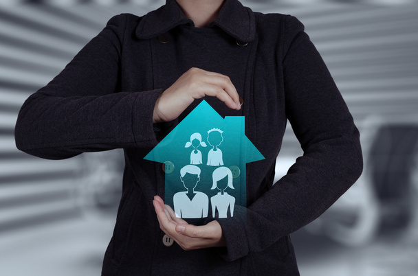 businessman hand holding 3d house with family icon as insurance  - Photo, Image