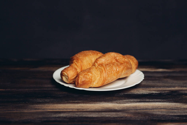 croissants plates wooden table drink mug breakfast dessert - Фото, изображение