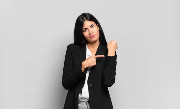 young hispanic businesswoman looking impatient and angry, pointing at watch, asking for punctuality, wants to be on time - Fotografie, Obrázek