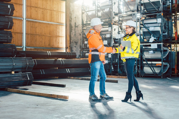 Handshake of worker and customer in warehouse - Photo, Image