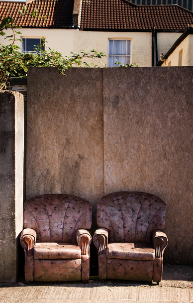 Armchairs on street or pavement in urban town area.trashed furniture, rubbish or litter by the road - Photo, Image