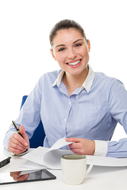 young smiling businesswoman looking at camera on her desk  - Photo, Image