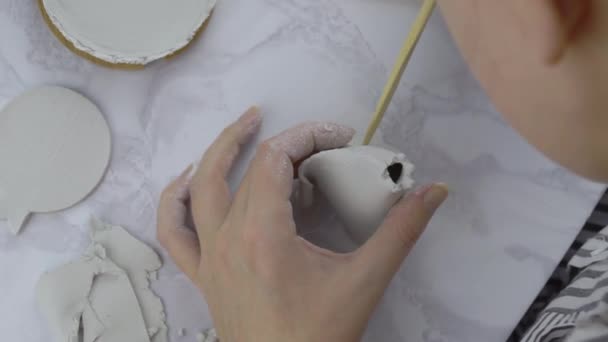 女性の手は木製の棒で粘土で作られたウィグワムで穴を作る. - 映像、動画
