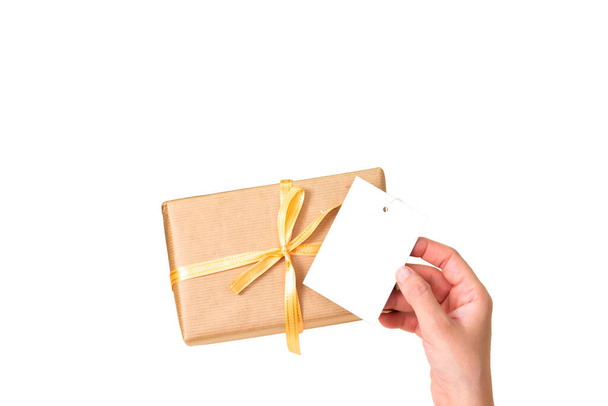 boîte cadeau avec main tenant une carte noire ou une étiquette isolée sur fond blanc - Photo, image