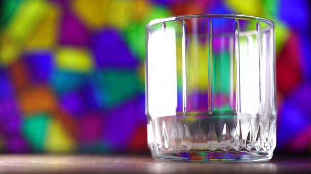 Colored wooden sticks fall into a glass. Multi-colored background. - Footage, Video