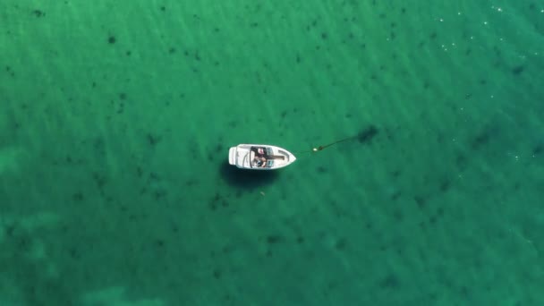 Aerial view of a fisher on a white drifting boat - Footage, Video