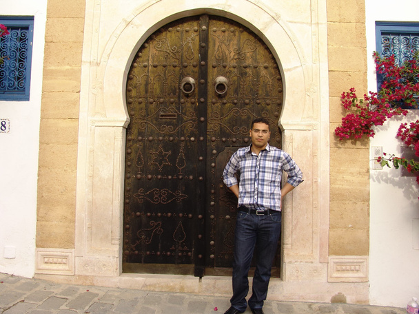 Man standing infront of the famous doors of Sidi Bou Said in Tunis, the capital of Tunisia. - Photo, Image