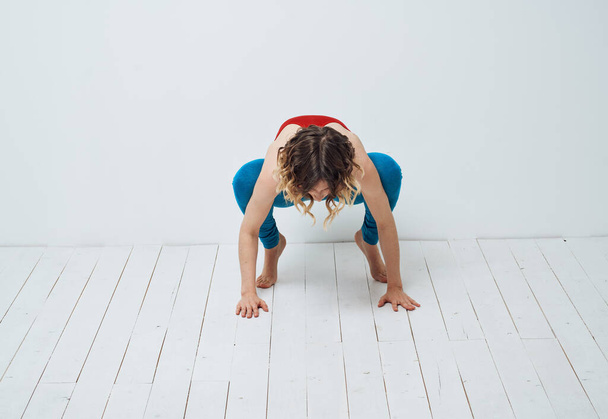 Sportive woman doing exercises on the floor yoga asana meditation - Photo, Image