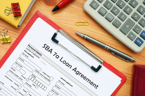 Концепция бизнеса по управлению малым бизнесом SBA 7a Кредитное соглашение с надписью на финансовом документе - Фото, изображение