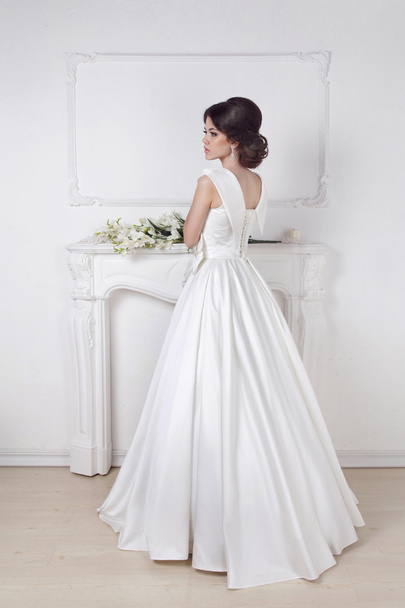 Beautiful charming bride in wedding luxurious dress posing again - Valokuva, kuva