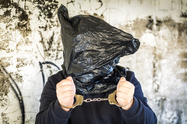 Hostage in handcuffs and with a bag on head - Zdjęcie, obraz