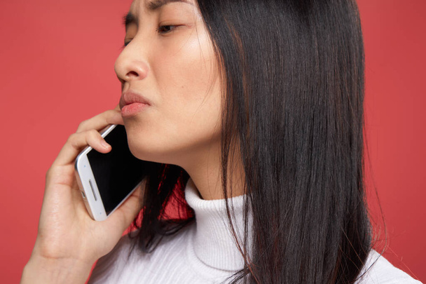 Asyalı kadın telefon iletişimi yaşam tarzı stüdyo yakın çekim teknolojisi ile ortaya çıkıyor. - Fotoğraf, Görsel