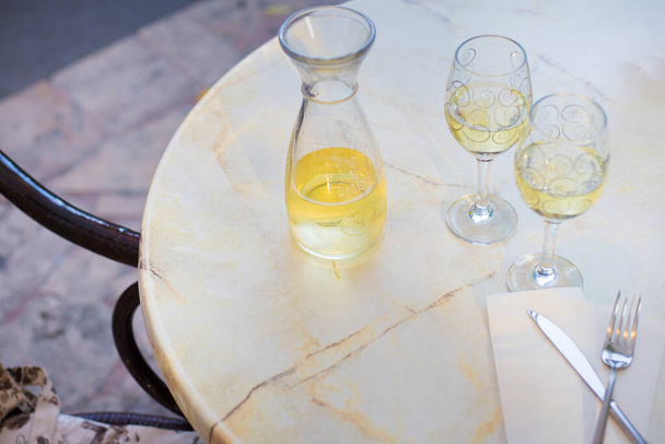 Vino blanco en botella de litro sobre una mesa en un café - Foto, imagen