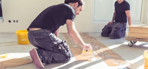 professional carpenters working together during home renovation - Foto, Imagen