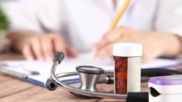 doctor hand writing prescription on desk, selective focus  - Footage, Video