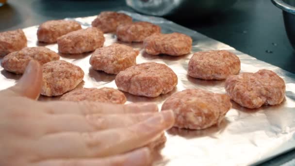 Close up video of  women's hands are cooking juicy meatballs, cutlets, nuggets, kebabs. Traditional home cooking. Raw minced meat on a kitchen board. Homemade recipe for cooking meat dishes.  - Felvétel, videó