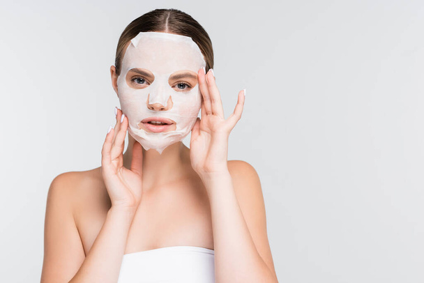 young woman with moisturizing sheet mask isolated on white - Photo, Image