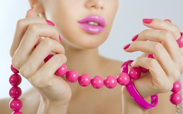 Beautiful girl with bright pink manicure and accessory close up - Foto, Imagem