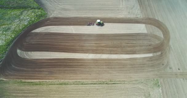 Tractor plowing field. Farmer working on wheat field. - Footage, Video