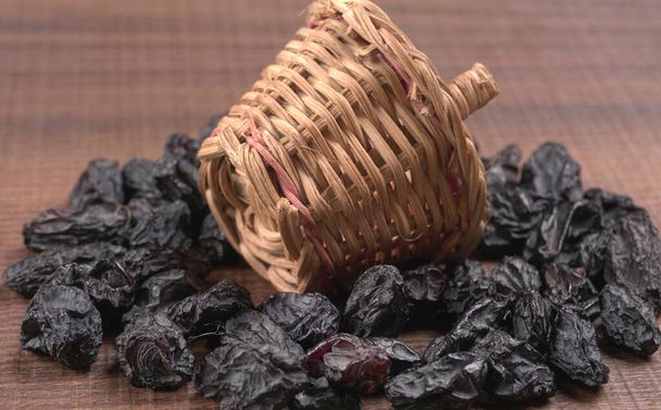 Organic dried Raisins isolated on wooden background. - Photo, Image
