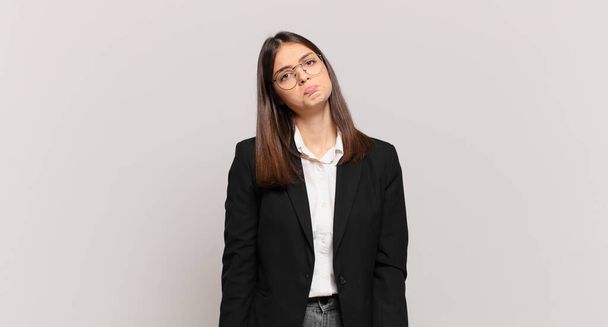 young business woman feeling sad and whiney with an unhappy look, crying with a negative and frustrated attitude - Foto, immagini