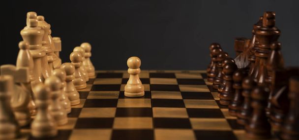 First step of white pawn on chess chessboard. Start concept. - Zdjęcie, obraz