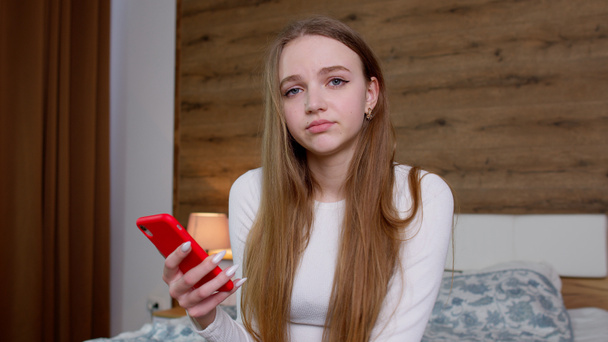 Sad upset dissatisfied irritated girl reading bad news on mobile phone, say no i do not need it - Photo, Image
