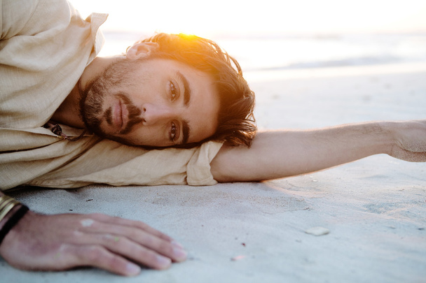 Man lying down on  beach - Фото, зображення