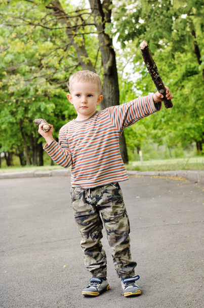 Little boy playing with fighting sticks - Photo, Image