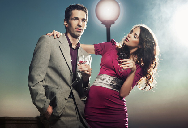 Attractive couple with glasses of wine - Фото, зображення