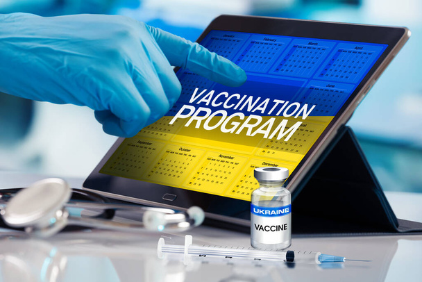 Professional working in calendar of vaccines plan for Ukraine nation, Immunization concept. Working with tablet in the program of the vaccination schedule for Ukraine. Photomontage with 3d illustration - Photo, Image