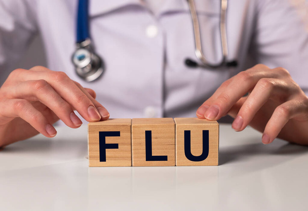 Flu word, inscription in doctor hands. Medical concept. - Foto, Imagen