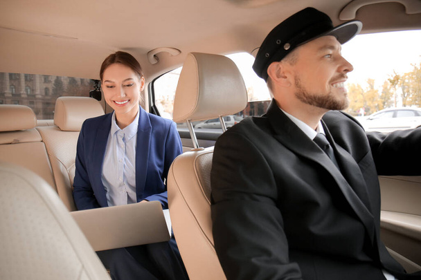 Chauffeur and passenger sitting in luxury car - Photo, Image