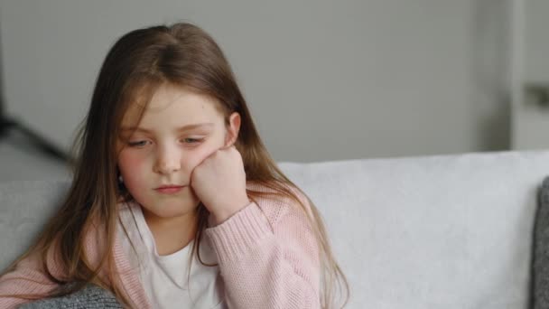 Portrait of offended child, close-up little sad upset preschool girl looking at camera sits at home, little bored alone daughter kid feels sadness after quarrel conflict punishment for bad behavior - Footage, Video