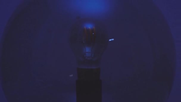 Andando via verso una lampada sferica che poi si accende in una stanza blu scuro - Filmati, video