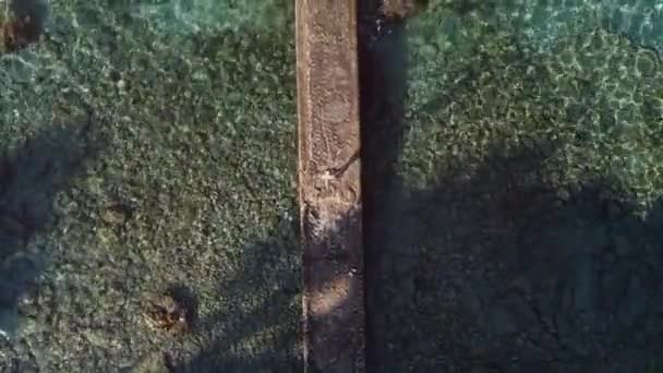 Дивовижний безпілотний вид на туристичну прогулянку по кам'яній набережній в оточенні махаючого моря з бірюзовою водою в сонячний день під час відпустки
 - Кадри, відео
